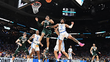 March 23, 2024, Charlotte, NC, USA; Michigan State Spartans guard Jaden Akins (3) and North Carolina Tar Heels guard RJ Davis (4) battle for a rebound in the second round of the 2024 NCAA Tournament at the Spectrum Center. Mandatory Credit: Bob Donnan-Imagn Images