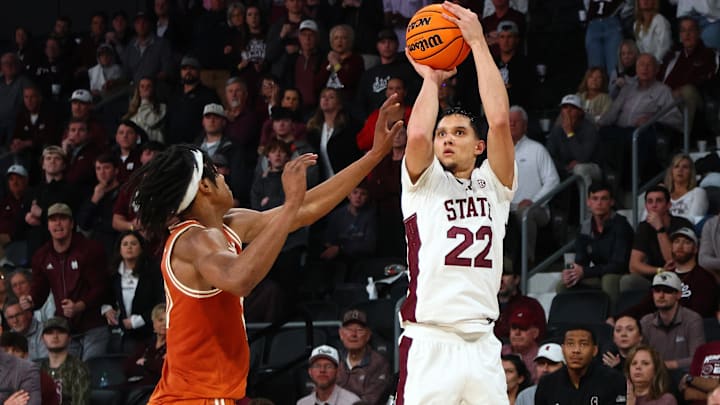 Mar 4, 2025; Starkville, Mississippi, USA; Mississippi State Bulldogs forward RJ Melendez (22) shoots for three as Texas Longhorns guard Tre Johnson (20) defends during overtime at Humphrey Coliseum. Mandatory Credit: Petre Thomas-Imagn Images