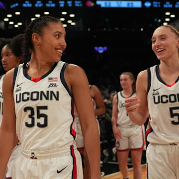 Connecticut Huskies guard Azzi Fudd (35) and Connecticut Huskies guard Paige Bueckers (5) celebrate after the game against the Louisville Cardinals at Barclays Center.