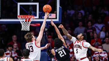 Dec 30, 2024; Tucson, Arizona, USA; TCU Horned Frogs Noah Reynolds (21) makes a layup against Arizona Wildcats forward Henri Veesaar (13) and Arizona Wildcats guard KJ Lewis (5) during the second half of the game at McKale Center. Mandatory Credit: Aryanna Frank-Imagn Images