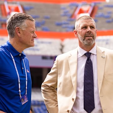 Sep 14, 2024; Gainesville, Florida, USA; Florida Gators athletic director Scott Stricklin (left) and head coach Billy Napier talk before a game against the Texas A&M Aggies at Ben Hill Griffin Stadium. Mandatory Credit: Matt Pendleton-Imagn Images