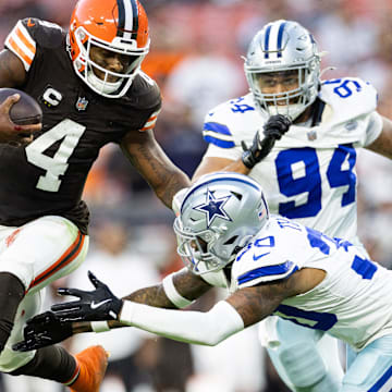 Sep 8, 2024; Cleveland, Ohio, USA; Cleveland Browns quarterback Deshaun Watson (4) leaps away from Dallas Cowboys safety Juanyeh Thomas (30) during the fourth quarter at Huntington Bank Field. Mandatory Credit: Scott Galvin-Imagn Images