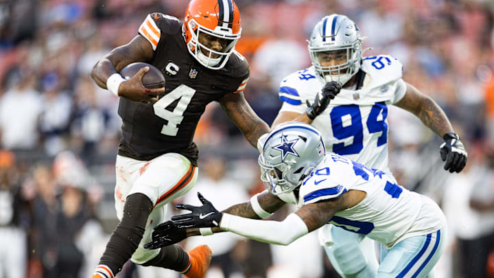 Sep 8, 2024; Cleveland, Ohio, USA; Cleveland Browns quarterback Deshaun Watson (4) leaps away from Dallas Cowboys safety Juanyeh Thomas (30) during the fourth quarter at Huntington Bank Field. Mandatory Credit: Scott Galvin-Imagn Images