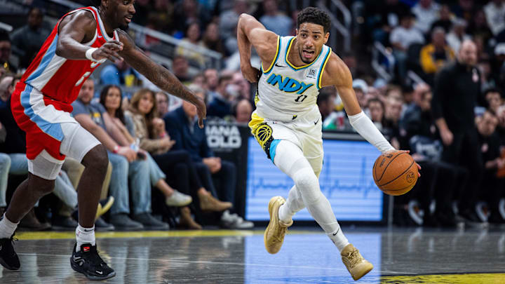 Feb 20, 2025; Indianapolis, Indiana, USA: Indiana Pacers guard Tyrese Haliburton (0) dribbles the ball while Memphis Grizzlies guard Vince Williams Jr. (5) defends in the second half at Gainbridge Fieldhouse. Mandatory Credit: Trevor Ruszkowski-Imagn Images