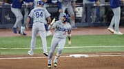 Los Angeles Dodgers second baseman Miguel Rojas (72) celebrates as he runs the bases after hitting a home run against the Toronto Blue Jays in the ninth inning during game seven of the 2025 MLB World Series at Rogers Centre on Saturday.