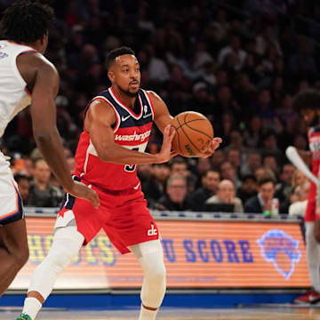 Nov 3, 2025; New York, New York, USA; Washington guard CJ McCollum (3) passes around New York Knicks forward OG Anunoby (8) during the second half at Madison Square Garden. Mandatory Credit: Lucas Boland-Imagn Images