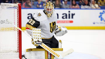 Mar 15, 2025; Buffalo, New York, USA;  Vegas Golden Knights goaltender Adin Hill (33) looks for the puck during the second period against the Buffalo Sabres at KeyBank Center. Mandatory Credit: Timothy T. Ludwig-Imagn Images