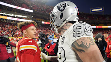 Nov 29, 2024; Kansas City, Missouri, USA; Kansas City Chiefs quarterback Patrick Mahomes (15) talks with Las Vegas Raiders defensive end Maxx Crosby (98) after a game at GEHA Field at Arrowhead Stadium. Mandatory Credit: Jay Biggerstaff-Imagn Images