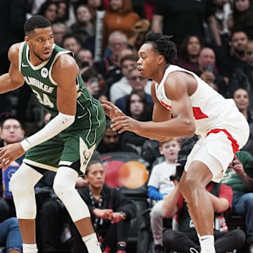 Jan 6, 2025; Toronto, Ontario, CAN; Milwaukee Bucks forward Giannis Antetokounmpo (34) controls the ball as Toronto Raptors forward Scottie Barnes (4) defends during the third quarter at Scotiabank Arena. Mandatory Credit: Nick Turchiaro-Imagn Images