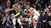 Jan 6, 2025; Toronto, Ontario, CAN; Milwaukee Bucks forward Giannis Antetokounmpo (34) controls the ball as Toronto Raptors forward Scottie Barnes (4) defends during the third quarter at Scotiabank Arena. Mandatory Credit: Nick Turchiaro-Imagn Images