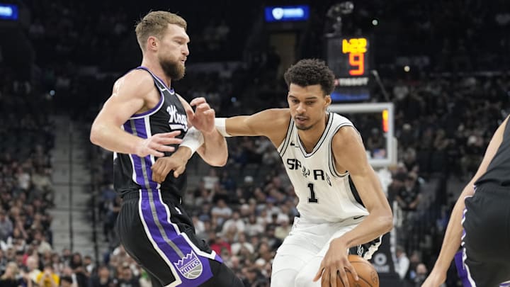 Nov 11, 2024; San Antonio, Texas, USA; San Antonio Spurs center Victor Wembanyama (1) drives to the basket while defended by Sacramento Kings center Domantas Sabonis (11) during the first half at Frost Bank Center. Mandatory Credit: Scott Wachter-Imagn Images