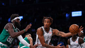 Nov 13, 2024; Brooklyn, New York, USA; Brooklyn Nets center Nic Claxton (33) passes the ball as Boston Celtics center Neemias Queta (88) defends during the second half at Barclays Center. Mandatory Credit: Vincent Carchietta-Imagn Images