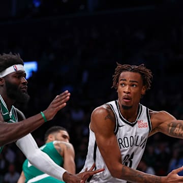 Nov 13, 2024; Brooklyn, New York, USA; Brooklyn Nets center Nic Claxton (33) passes the ball as Boston Celtics center Neemias Queta (88) defends during the second half at Barclays Center. Mandatory Credit: Vincent Carchietta-Imagn Images