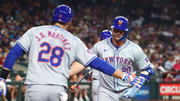 Aug 27, 2024; Phoenix, Arizona, USA; New York Mets first baseman Pete Alonso (right) celebrates with J.D. Martinez after hitting a solo home run in the second inning against the Arizona Diamondbacks at Chase Field. Mandatory Credit: Mark J. Rebilas-USA TODAY Sports