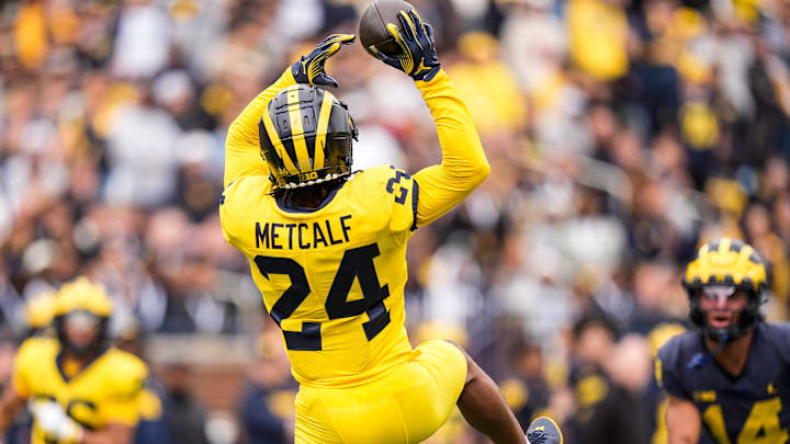 Team Maize defensive back Tevis Metcalf (24) intercepts a pass from Team Blue quarterback Bryce Underwood (19) during the first half of the spring game at Michigan Stadium in Ann Arbor on Saturday, April 19, 2025.