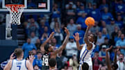 Kentucky Wildcats guard Otega Oweh puts up the game-winning shot over Oklahoma Sooners forward Jalon Moore as the clock wound down during their second round game of the SEC Men's Basketball Tournament at Bridgestone Arena in Nashville, Tenn., Thursday, March 13, 2025.