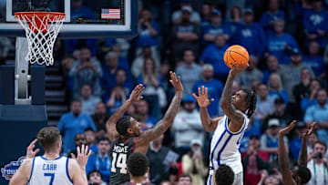 Kentucky Wildcats guard Otega Oweh puts up the game-winning shot over Oklahoma Sooners forward Jalon Moore as the clock wound down during their second round game of the SEC Men's Basketball Tournament at Bridgestone Arena in Nashville, Tenn., Thursday, March 13, 2025.