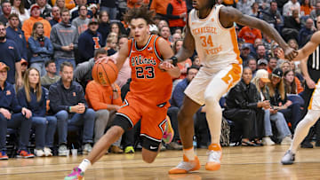 Dec 6, 2025; Nashville, Tennessee, USA;  Illinois Fighting Illini guard Keaton Wagler (23) drives to the baseline past Tennessee Volunteers center Felix Okpara (34) during the second half at Bridgestone Arena. Mandatory Credit: Steve Roberts-Imagn Images
