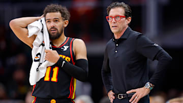 Trae Young #11 and Atlanta Hawks head coach Quin Snyder look on against the Denver Nuggets.