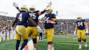 Notre Dame offensive lineman Sullivan Absher (75) and offensive lineman Joe Otting (64) celebrate after a touchdown scored by running back Jeremiyah Love (4) in the first half of a NCAA football game against Syracuse at Notre Dame Stadium on Saturday, Nov. 22, 2025, in South Bend.