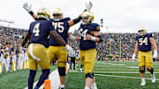 Notre Dame offensive lineman Sullivan Absher (75) and offensive lineman Joe Otting (64) celebrate after a touchdown scored by running back Jeremiyah Love (4) in the first half of a NCAA football game against Syracuse at Notre Dame Stadium on Saturday, Nov. 22, 2025, in South Bend.