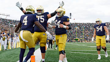 Notre Dame offensive lineman Sullivan Absher (75) and offensive lineman Joe Otting (64) celebrate after a touchdown scored by running back Jeremiyah Love (4) in the first half of a NCAA football game against Syracuse at Notre Dame Stadium on Saturday, Nov. 22, 2025, in South Bend.