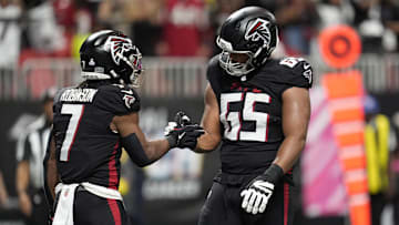 Atlanta Falcons running back Bijan Robinson celebrates with guard Matthew Bergeron 