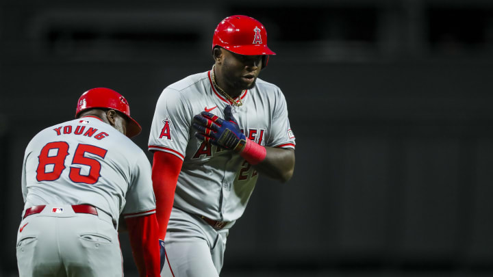 Apr 20, 2024; Cincinnati, Ohio, USA; Los Angeles Angels designated hitter Miguel Sano (22) high fives third base coach Eric Young Sr. (85) after hitting a two-run home run in the sixth inning against the Cincinnati Reds at Great American Ball Park.
