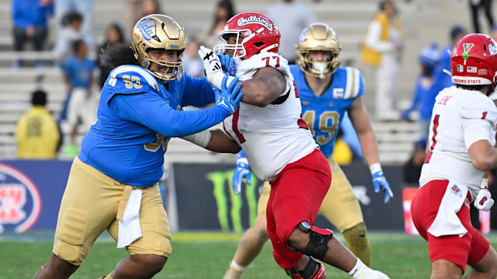 Nov 30, 2024; Pasadena, California, USA; UCLA Bruins defensive lineman Jay Toia (93) tangles with Fresno State Bulldogs offensive lineman Toreon Penright (77) during the fourth quarter at Rose Bowl. Mandatory Credit: Robert Hanashiro-Imagn Images Nov 30, 2024; Pasadena, California, USA; UCLA Bruins defensive lineman Jay Toia (93) tangles with Fresno State Bulldogs offensive lineman Toreon Penright (77) during the fourth quarter at Rose Bowl. Mandatory Credit: Robert Hanashiro-Imagn Images