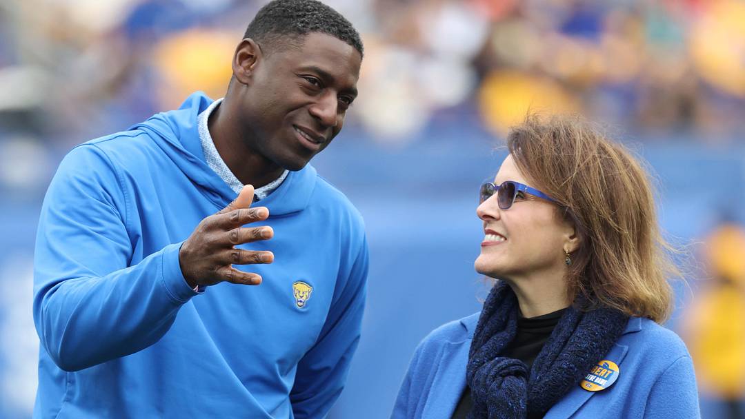 Nov 15, 2025; Pittsburgh, Pennsylvania, USA;  University of Pittsburgh Athletic Director Allen Greene (left) talks with university Chancellor Joan Gabel (right) during halftime against the Notre Dame Fighting Irish at Acrisure Stadium. Mandatory Credit: Charles LeClaire-Imagn Images
