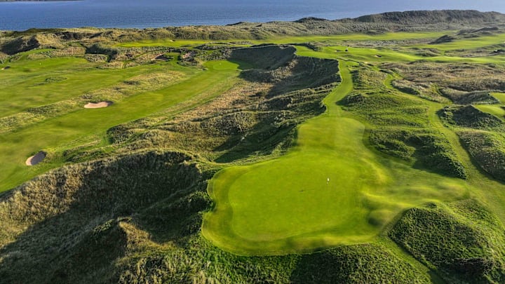 An aerial view of the 206-yard par-3 16th hole "Calamity Corner" at Royal Portrush Golf Club. 