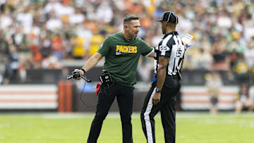 Sep 21, 2025; Cleveland, Ohio, USA; Green Bay Packers head coach Matt LaFleur argues a call with line judge Walt Coleman IV (65) during the fourth quarter at Huntington Bank Field. Mandatory Credit: Scott Galvin-Imagn Images