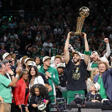 Jun 17, 2024; Boston, Massachusetts, USA; Boston Celtics forward Jayson Tatum (0) lifts the trophy after winning the 2024 NBA Finals against the Dallas Mavericks at TD Garden. Mandatory Credit: Peter Casey-USA TODAY Sports