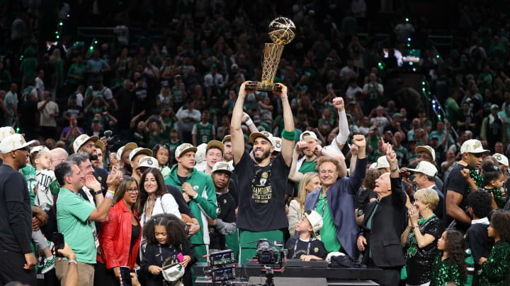 Jun 17, 2024; Boston, Massachusetts, USA; Boston Celtics forward Jayson Tatum (0) lifts the trophy after winning the 2024 NBA Finals against the Dallas Mavericks at TD Garden. Mandatory Credit: Peter Casey-USA TODAY Sports