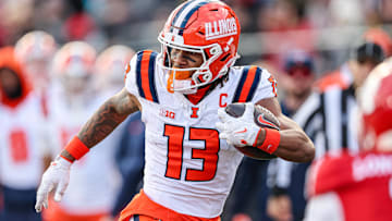 Nov 23, 2024; Piscataway, New Jersey, USA; Illinois Fighting Illini wide receiver Pat Bryant (13) gains yards after catch during the second half against the Rutgers Scarlet Knights at SHI Stadium. Mandatory Credit: Vincent Carchietta-Imagn Images