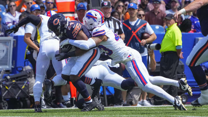 Aug 10, 2024; Orchard Park, New York, USA; Chicago Bears running back Khalil Herbert (24) runs with the ball and is tackled by Buffalo Bills linebacker Terrel Bernard (43) during the first half at Highmark Stadium.  