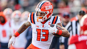 Nov 23, 2024; Piscataway, New Jersey, USA; Illinois Fighting Illini wide receiver Pat Bryant (13) gains yards after catch during the second half against the Rutgers Scarlet Knights at SHI Stadium. Mandatory Credit: Vincent Carchietta-Imagn Images