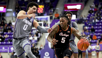 Feb 12, 2025; Fort Worth, Texas, USA; Oklahoma State Cowboys guard Khalil Brantley (5) dribbles as TCU Horned Frogs guard Brendan Wenzel (0) defends during the second half at Ed and Rae Schollmaier Arena. Mandatory Credit: Kevin Jairaj-Imagn Images