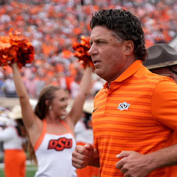 Oklahoma State head football coach Mike Gundy runs on to the field in the first half of the college football game between the Oklahoma State Cowboys and South Dakota State Jackrabbits at Boone Pickens Stadium in Stillwater, Okla., Saturday, Aug., 31, 2024.