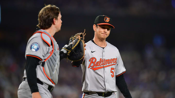 Aug 27, 2024; Los Angeles, California, USA; Baltimore Orioles catcher Adley Rutschman greets pitcher Matt Bowman.