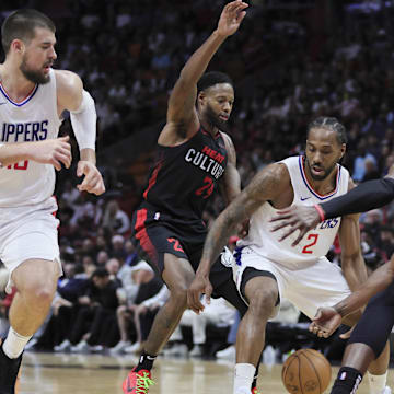 LA Clippers forward Kawhi Leonard (2) protects the basketball from Miami Heat forward Haywood Highsmith (24) and center Bam Adebayo (13) during the third quarter at Kaseya Center. Mandatory Credit: Sam Navarro-Imagn Images