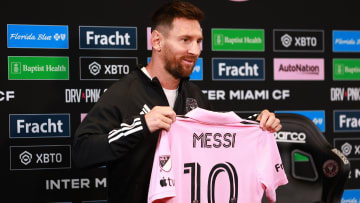Inter Miami's Lionel Messi shows off his shirt to reporters during a recent news conference in Ft. Lauderdale.