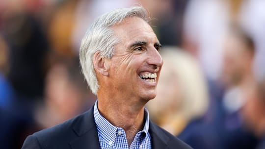 Sep 3, 2017; Landover, MD, USA; West Virginia Mountaineers former athletic director Oliver Luck smiles as he walks on the sidelines at FedEx Field. Mandatory Credit: Ben Queen-Imagn Images