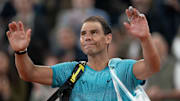 Rafael Nadal waves to the French Open crowd after a loss.