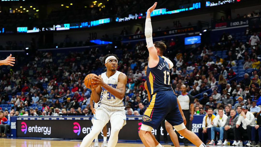 Mar 9, 2022; New Orleans, Louisiana, USA; Orlando Magic center Wendell Carter Jr. (34) drives to the basket against New Orleans Pelicans center Jonas Valanciunas (17) during the third quarter at Smoothie King Center.