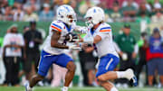 Aug 28, 2025; Tampa, Florida, USA; Boise State Broncos quarterback Maddux Madsen (4) hands off to Boise State Broncos running back Malik Sharrod (8) against the South Florida Bulls in the second quarter at Raymond James Stadium. M