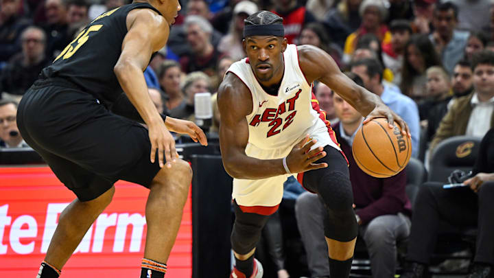 Mar 20, 2024; Cleveland, Ohio, USA; Miami Heat forward Jimmy Butler (22) drives against Cleveland Cavaliers forward Isaac Okoro (35) in the second quarter at Rocket Mortgage FieldHouse. Mandatory Credit: David Richard-Imagn Images