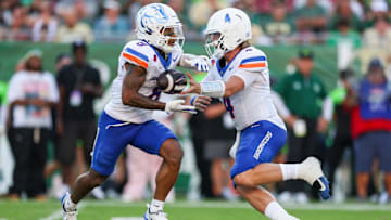 Boise State quarterback Maddux Madsen hands off to running back Malik Sharrod.
