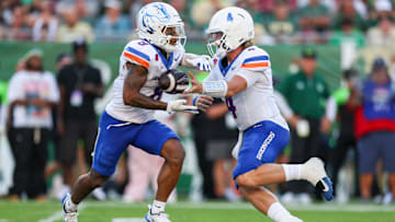 Boise State quarterback Maddux Madsen hands off to Malik Sherrod.