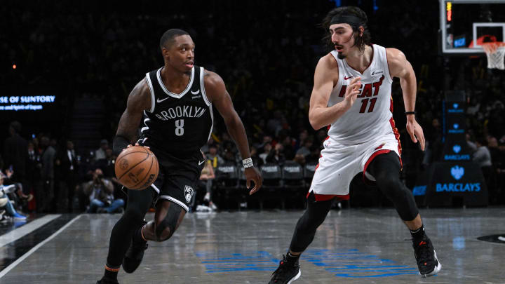 Nov 25, 2023; Brooklyn, New York, USA; Brooklyn Nets guard Lonnie Walker IV (8) drives against Miami Heat guard Jaime Jaquez Jr. (11) during the third quarter at Barclays Center. Mandatory Credit: John Jones-USA TODAY Sports